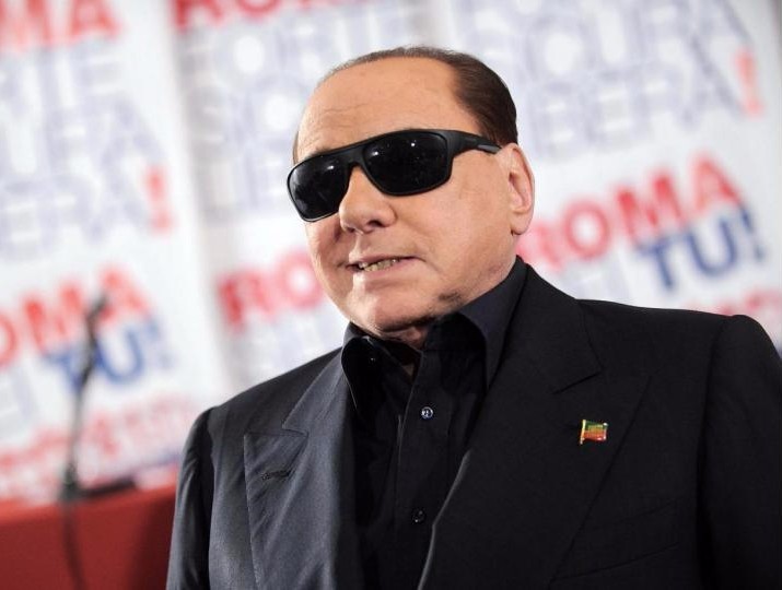 Berlusconi versione “Blues Brother”, occhiali e completo black
