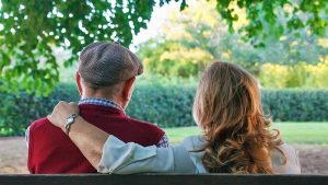 senior couple sitting on a bench
