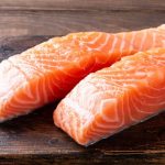 Fresh raw salmon fillet. Old wooden background. Banner selective focus.